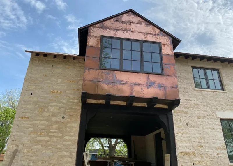 Copper metal panel facade on a stone building for Skylight Installation in Sault Ste. Marie